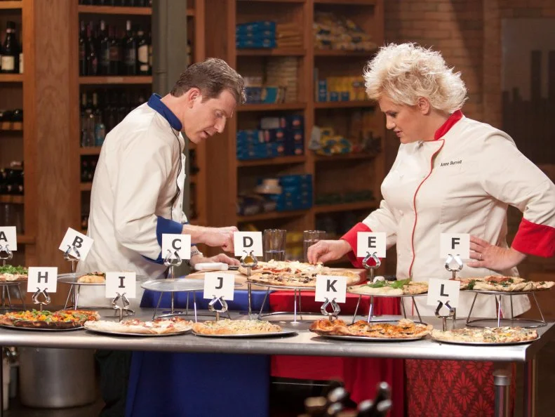 Worst Cooks in America Team Leaders Anne Burrell and Bobby Flay taste pizzas the recruits prepared in a blind taste test for the "Slice of Flavor" Skill Drill Challenge as seen on Food Network's Worst Cooks in America, Season 3.