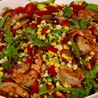 Grilled shrimp and corn salad is served as a side dish.