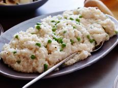 EASY PARMESAN â  RISOTTOâ  Ina GartenBarefoot Contessa/Dare To Be DifferentFood NetworkArborio Rice, Chicken Stock, Parmesan Cheese, Dry White Wine, Unsalted Butter, Kosher Salt,Pepper, Frozen Peas