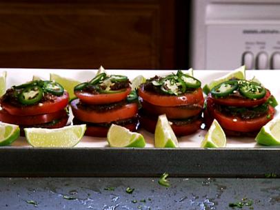 Spicy tomato napoleon is served with a black bean and roasted jalapeno sauce and lime wedges.