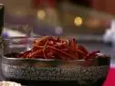 A bowl of sweet potato fires are garnished with salt.