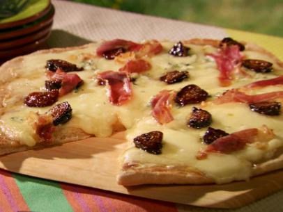 A Four Cheese Fig and Prosciutto Pie is served.