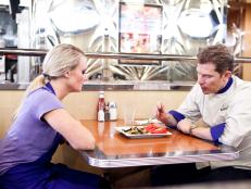 Chef Bobby Flay tastes Melissa Rhodes Walnut-Dijon Flank Steak Nachos at the TIck-Tock Diner after the Late Night Nachos Challenge, as seen on Food Network’s Worst Cooks in America, Season 3.