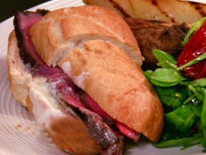 Grilled Steak Sandwich and tossed salad is served.