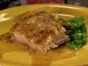 A sliced of crispy mustard braised pork belly is served.