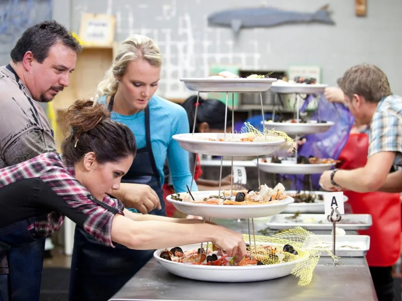 At the fish market, Wild Edibles, Red Team and Blue Team plate seafood for a raw bar for the Everything Seafood challenge as seen on Food Network's Worst Cooks in America, Season 3.