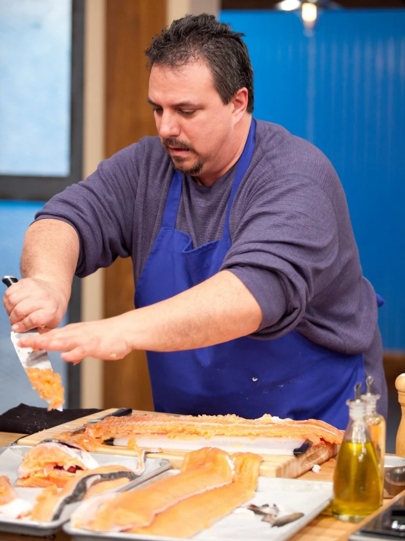 Vinni Caligiuri filets a fish for the Everything Seafood Challenge as seen on Food Network's Worst Cooks in America, Season 3.