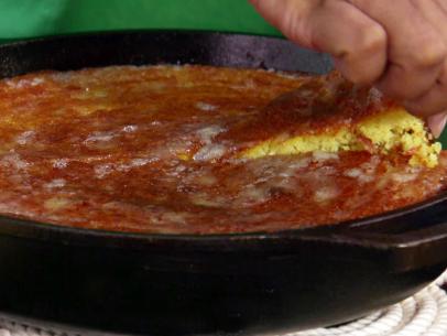 A slice of bacon and green chili cornbread is served.