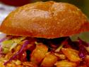 Rachael Ray's slow cooked bbq pulled chicken on a roll with homemade slaw salad.