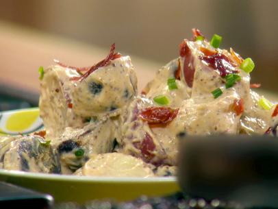 A close up of prosciutto and potato salad made by Sunny Anderson.