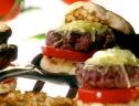 A close up of Melissa d'Arabian's perfect basil burgers on a toasted english muffin with fresh tomato, mozzarella, and a creamy basil sauce.