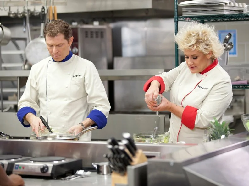 Chefs Bobby Flay and Anne Burrell demonstrate how to create healthy and kid-friendly cafeteria food for students at an elementary school in the Cooking for Kids Challenge as seen on Food Network's Worst Cooks in America, Season 3.