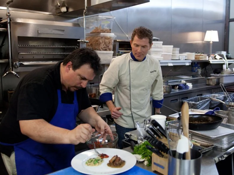 Worst Cooks in America Blue Team Leader Chef Bobby Flay oversees as Finalist Vinnie Caligiuri plates his entree course. Vinnie prepared a three course meal for a panel of judges who will determine the winner of this season's Worst Cooks in America.  Vinnie's menu is as follows: His Appetizer is Yellowtail Tartare, Bacon Tangerine Dressing, Toasted Fennel Croutons.  His Entree is Pan Roasted Squab, Marsala Sauce, Piquillo Pepper/ Black Olive Relish, Broccoli Rabe Risotto.  His Dessert is Pistachio Creme Brulee, Blackberry Pomegranate Salad as seen on Food Network's Worst Cooks in America-Season Three.