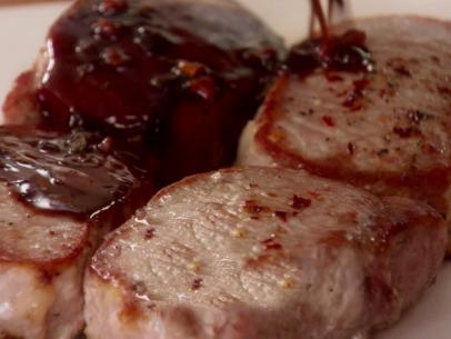 Sweet and sour glaze is poured over spiced pork chops.