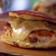 Chicken chorizo patty melts are served on a cutting board.
