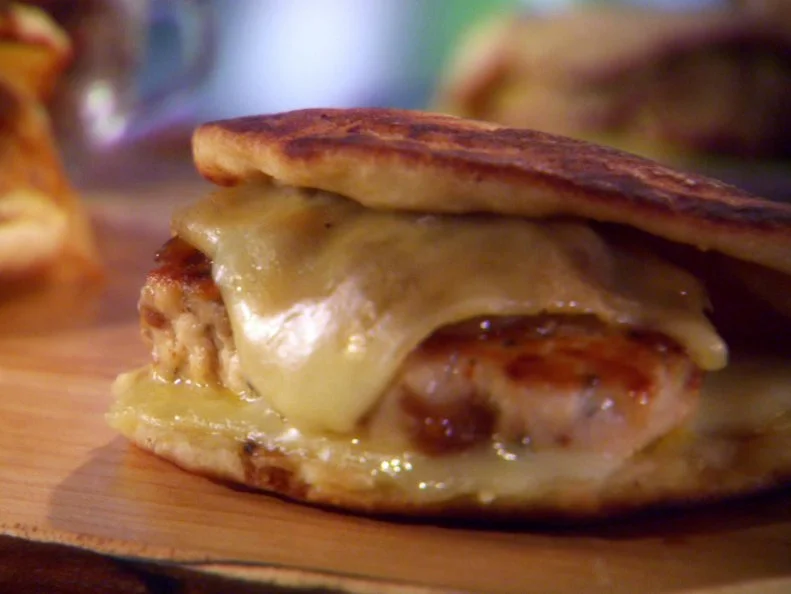 Chicken chorizo patty melts are served on a cutting board.