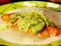 Cabbage and avocado top the fish taco.