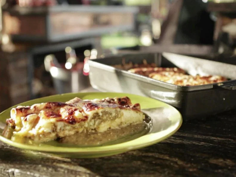 Guy Fieri makes turkey enchiladas in his outdoor kitchen.
