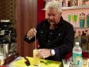 Guy Fieri stirs the cocktail.