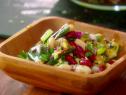 Zucchini bean salad is served in a wooden bowl.