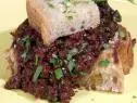 Close up of sloppy joe sandwich on a yellow plate.