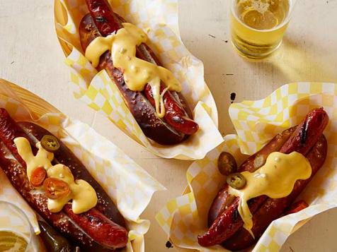 Pretzel Buns with Grilled Dogs and Spicy Cheese Sauce