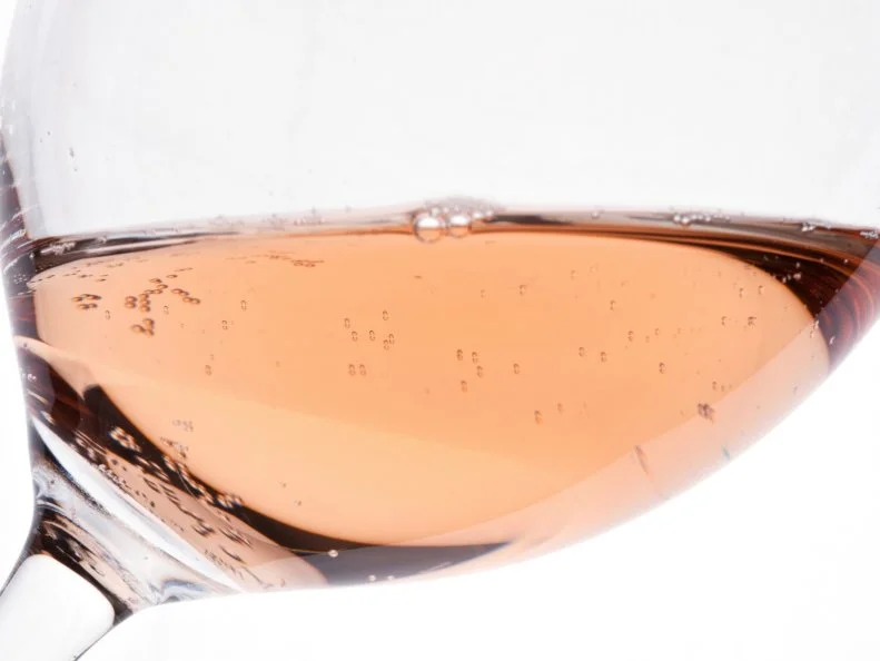 Glass of rose wine in the backlight