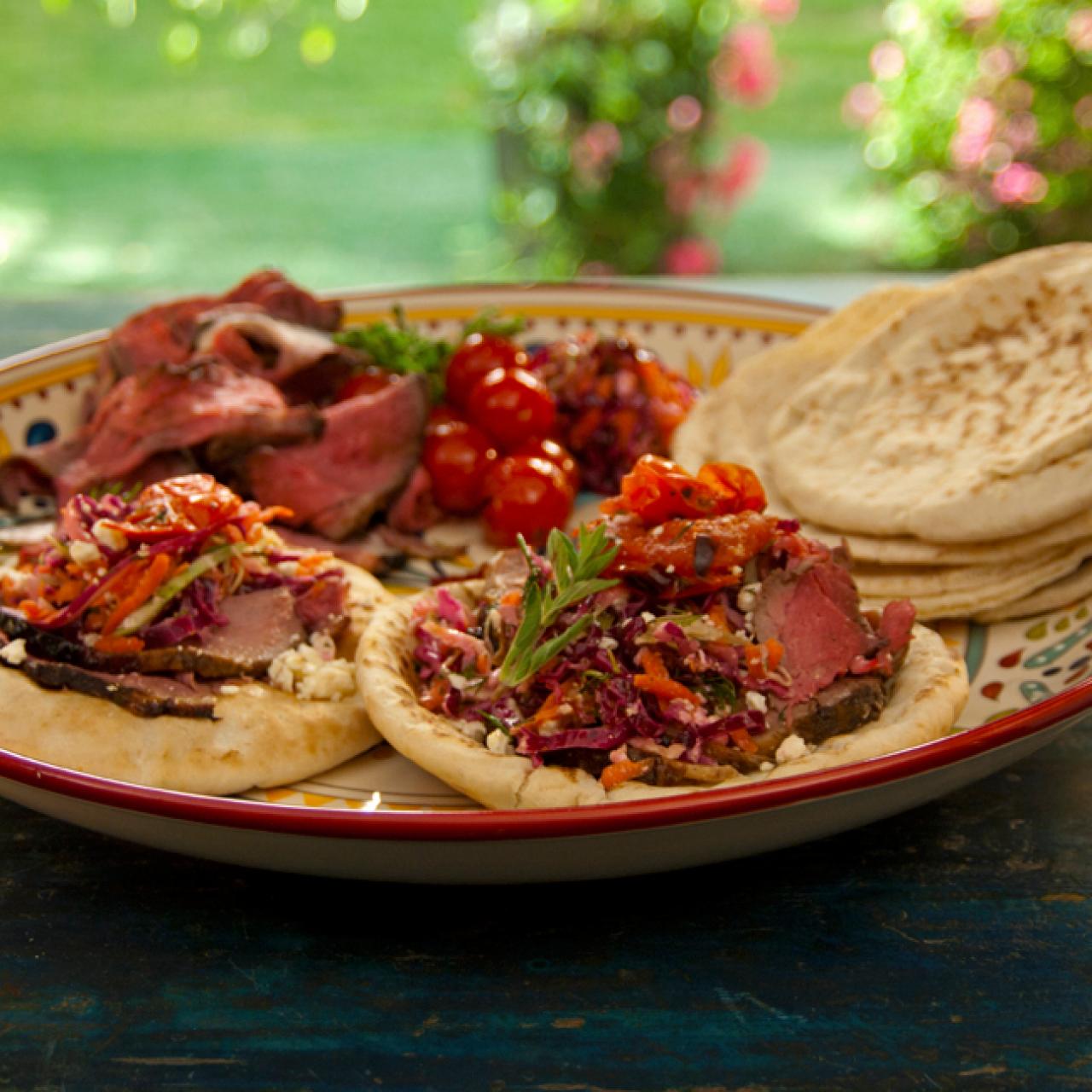 https://food.fnr.sndimg.com/content/dam/images/food/fullset/2012/6/20/0/QF0208_Open-Faced-Pitas-with-Rotisserie-Lamb-with-Pomegranate-and-Mint-Grilled-Tomatoes-and-Greek-Slaw-Recipe_s4x3.jpg.rend.hgtvcom.1280.1280.suffix/1382541475168.jpeg