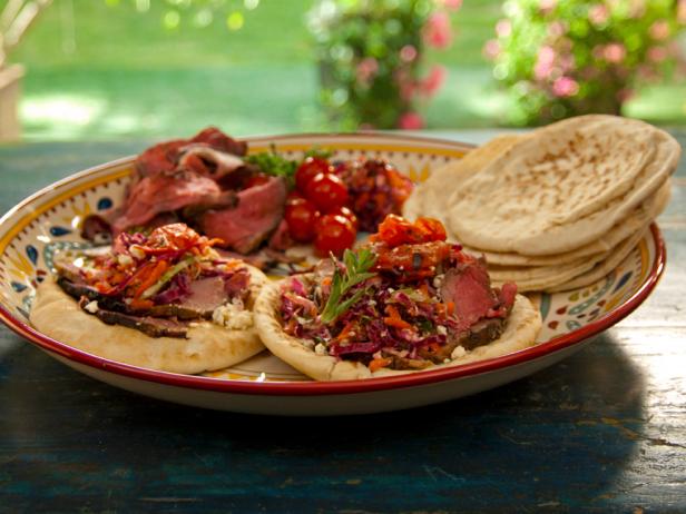 Open-Faced Pitas with Rotisserie Lamb with Pomegranate and Mint, Grilled Tomatoes, and Greek Slaw image