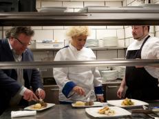 Anne Burrell and David Burke sample dark meat and liver sausage prepared by Chef Phil Definna, right, in the kitchen of Fromagerie as seen on Food Network’s The Anne Burrell Project, Season 1.