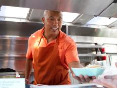 Contestant Hines Ward serving lunch truck customers for the "Lunch Truck" Challenge, as seen on Food Network’s Rachael vs. Guy, Celebrity Cook-Off, Season 2.

