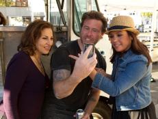 Contestants Kathy Najimy and Dean McDermott taking a break with Team Leader Rachael Ray after the "Lunch Trucks'' Challenge, as seen on Food Network’s Rachael vs. Guy, Celebrity Cook-Off, Season 2.
