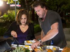 Contestants Kathy Najimy participating in the elimination cook-off as contestant Dean McDermott looks on, as seen on Food Network’s Rachael vs. Guy, Celebrity Cook-Off, Season 2.
