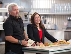 Host/Team Leaders Rachael Ray and Guy Fieri giving instructions for the "Mel's Drive In" Challenge, as seen on Food Network’s Rachael vs. Guy, Celebrity Cook-Off, Season 2.
