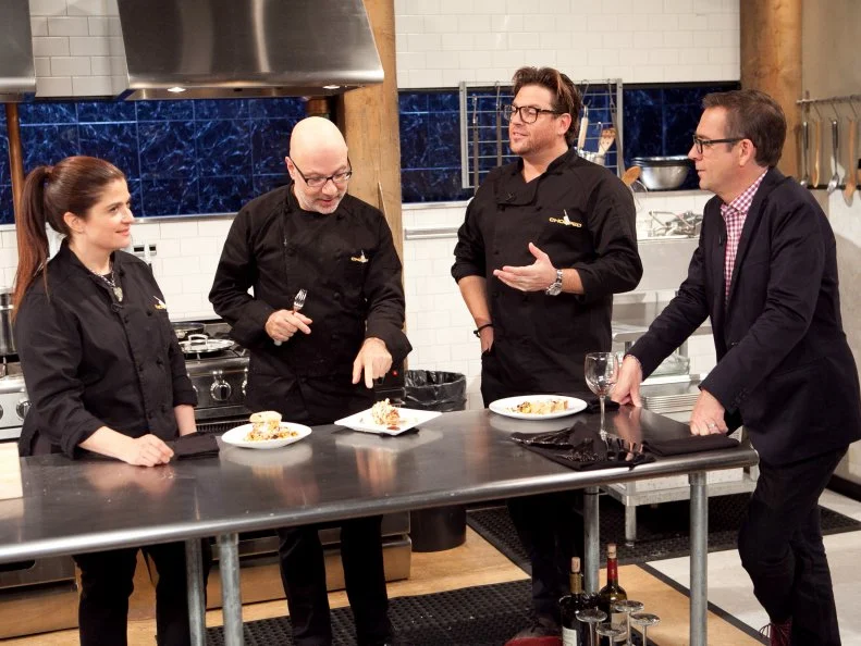 Host Ted Allen and After Hours Chefs: Alex Guarnaschelli, Ron Ben-Israel and Scott Conant discuss their dishes the were made with: popcorn, sour cream, funnel cake and blue snow cones, as seen on Food Network's Chopped: After Hours.