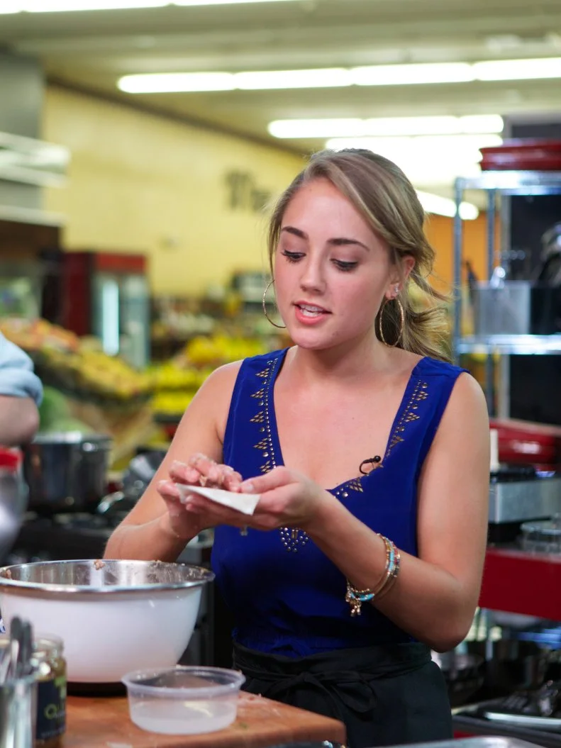 Chef Nia Pullinzi during the cooking part of Game 1, Out of Stock, Spaghetti and Meatballs, No pasta or Ground beef, 30 min time limit, as seen on Food Network's Guy's Grocery Games, Season 1.