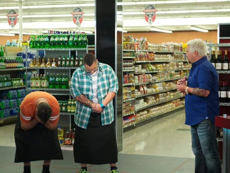 Host Guy Fieri with chefs Nick Wilson and Kris Plummer during the judging part of Game 3, Closing Time, Decadent Pasta, as seen on Food Network's Guy's Grocery Games, Season 1. Chef Kris Plummer wins Game 3.