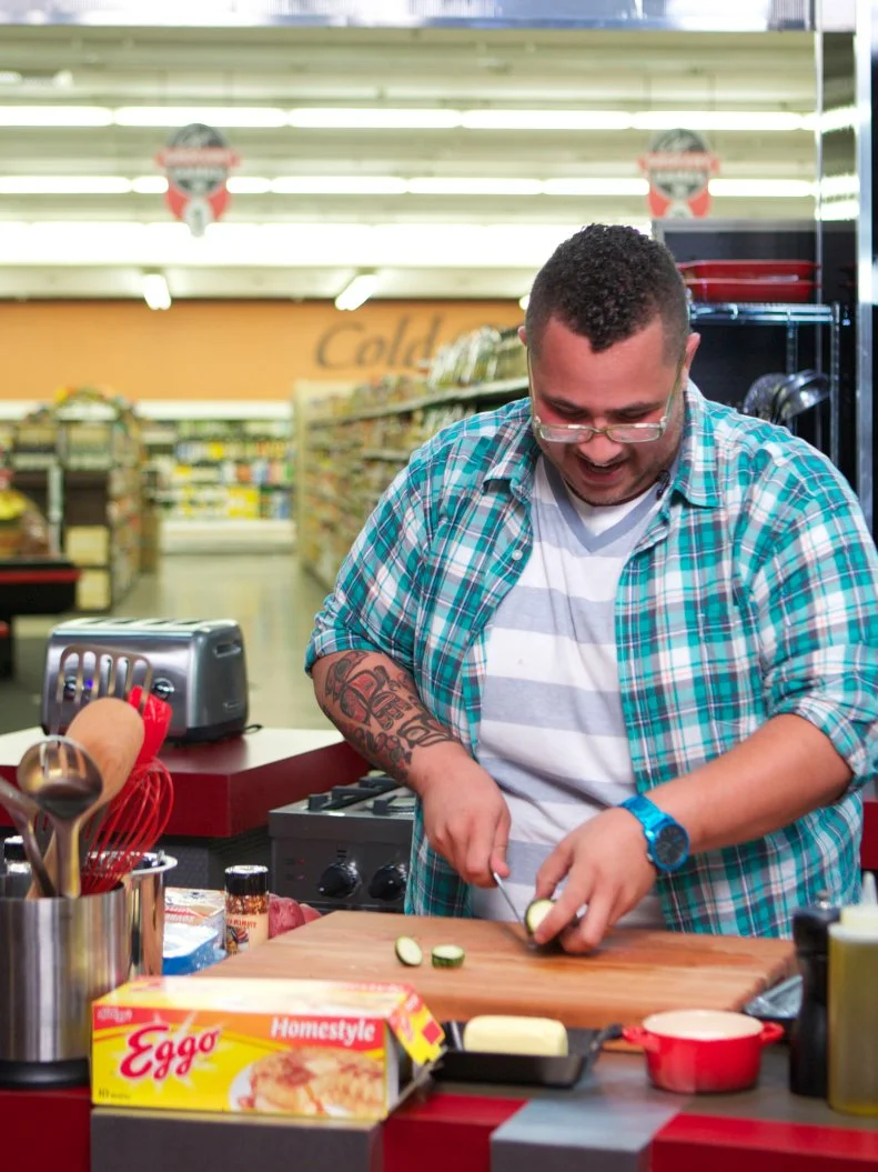Chef Nick Wilson during the cooking portion of Game 2, Grocery List, Fun Family Meals, with Ad Sales Integration featuring Kellogg's Eggo's, Kellogg's Eggo's Homestyle Waffles, as seen on Food Network's Guy's Grocery Games, Season 1.