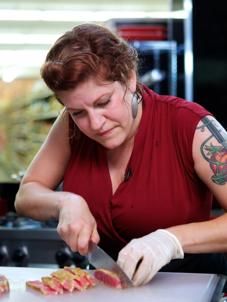 Chef Cristina Topham during the cooking part of Game 1, Out of Stock, Gourmet Salad, All Leafy Greens and Lettuce removed, 30 minute time limit, as seen on Food Network's Guy's Grocery Games, Season 1.