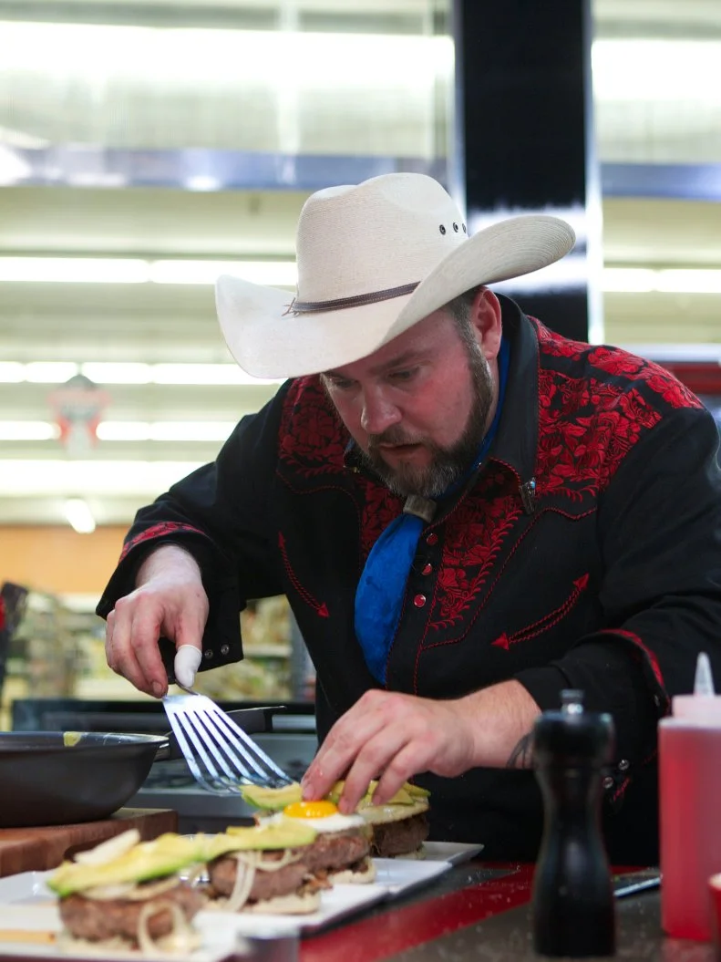 Chef Lenny McNab during the cooking part of Game 2, Budget Battle, Decadent Burgers for 4, Budget of $7.96 with coupons in play, 30 minute time limit, as seen on Food Network's Guy's Grocery Games, Season 1.