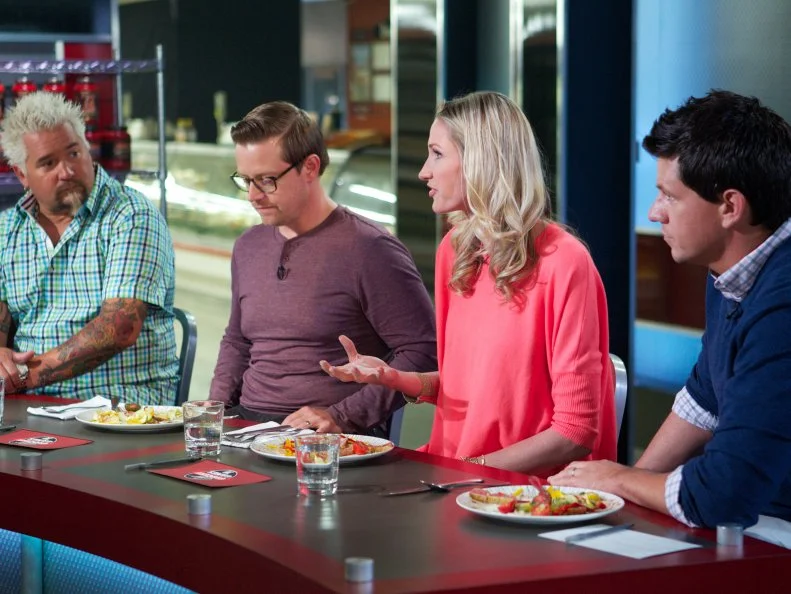 Host Guy Fieri with judges Richard Blais, Catherine McCord, and Troy Johnson during the judging of Game 1, Out of Stock, Gourmet Salad, All Leafy Greens and Lettuce removed, as seen on Food Network's Guy's Grocery Games, Season 1.