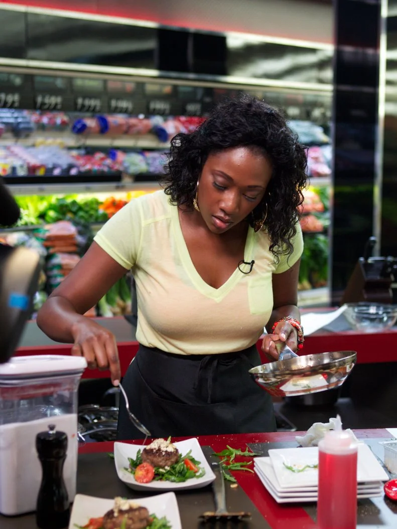 Chef Jessica Swift during the cooking part of Game 2, Budget Battle, Decadent Burgers for 4, Budget of $7.96 with coupons in play, 30 minute time limit, as seen on Food Network's Guy's Grocery Games, Season 1.
