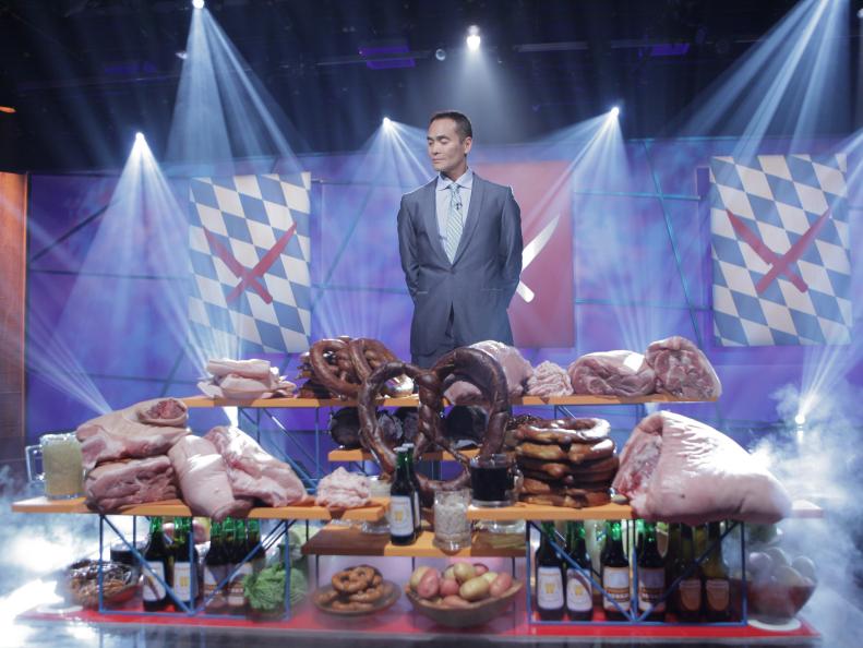 Mark Dacascos "The Chairman," introduces the Octoberfest theme to Challenger Chef BERNHARD MAIRINGER, and Iron Chef's MICHAEL SYMON, and GEOFFREY ZAKARIAN, in studio kitchen during the Octoberfest battle as seen on Food Network’s Iron Chef America.
