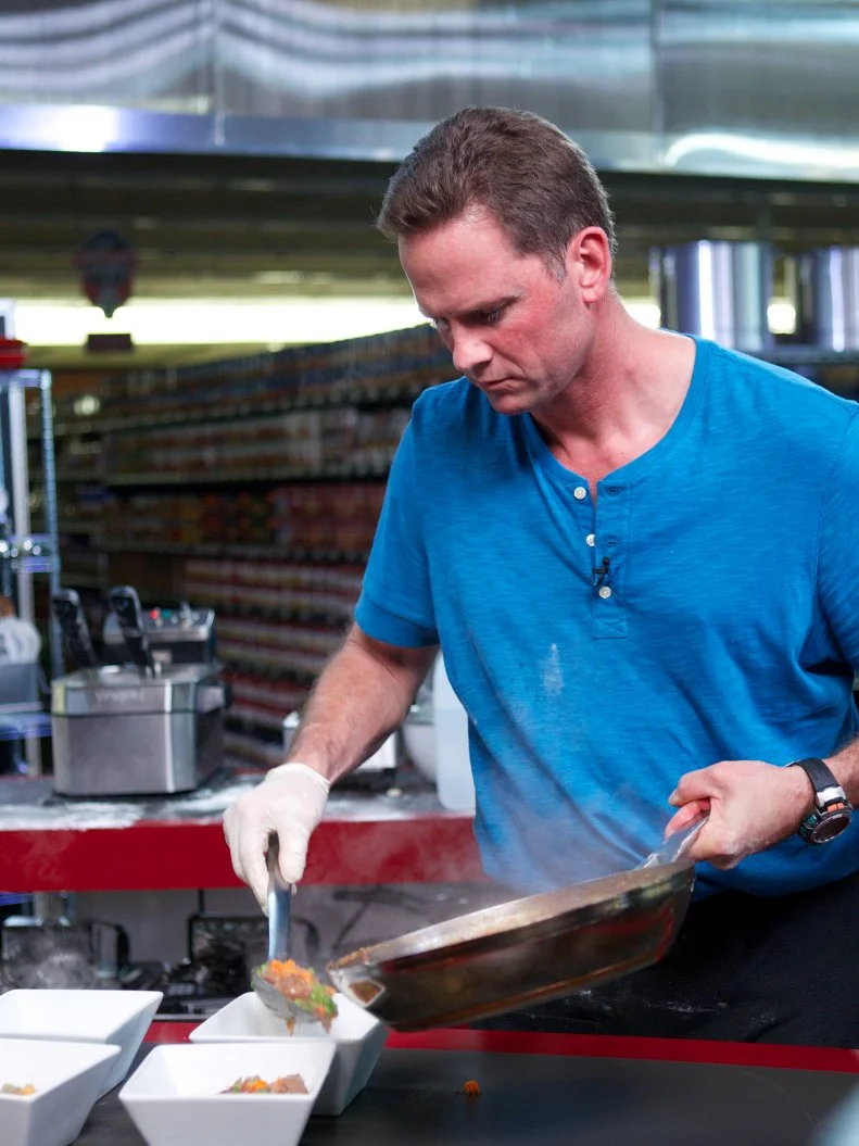 Chef Mark Curry during the cooking part of Game 3, Closing Time, Savory Pie, 3 min to shop and 30 min cooking time, as seen on Food Network's Guy's Grocery Games, Season 1.