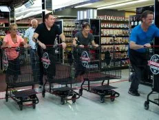 Host Guy Fieri with chefs Lisa Stalvey, Timothy Abell, Lisa Guantt, and Mark Curry during the start of the shopping part of Game 1, Frozen Food Feud, Five Star Dinner, 30 min cooking time, as seen on Food Network's Guy's Grocery Games, Season 1.