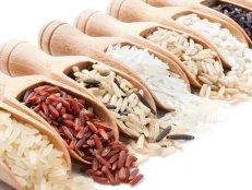 Wooden scoops with different rice types scattered from them