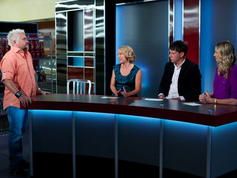 Host Guy Fieri with judges Melissa D'Arabian, Troy Johnson, and Catherine McCord during the judging of Game 1, Grocery List, Best Egg Dish, 30 min cooking time, as seen on Food Network's Guy's Grocery Games, Season 1.