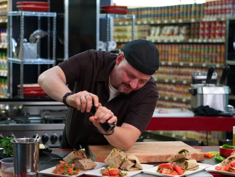 Chef Luca Paris during the cooking part of Game 3, Bag Swap, Gourmet Lunch, 3 min to shop and 30 min cooking time, as seen on Food Network's Guy's Grocery Games, Season 1.