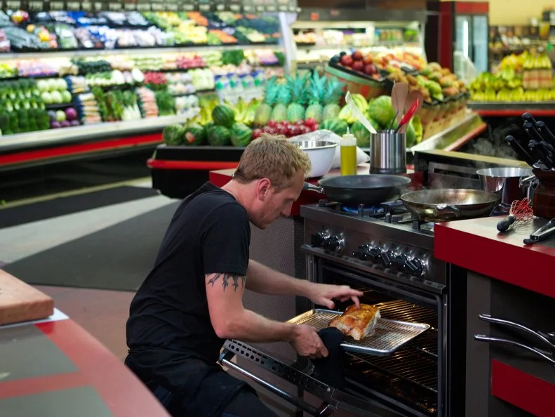 Chef Aram Reed during the cooking part of Game 3, Grocery Bag secretly Bag Swap after shopping, Holiday Celebration, 1 main dish and 2 sides, 4 min to shop and 35 min cooking time, as seen on Food Network's Guy's Grocery Games, Season 1.