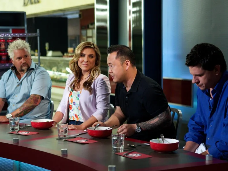 Host Guy Fieri with judges Lorena Garcia, Jet Tila, and Troy Johnson during the judging part  the judging part of Game 2, Grocery List, Mexican Fiesta, Ad Sale integration Kikkoman Soy Sauce, must have Kikkoman Soy Sauce, 30 minute time limit, as seen on Food Network's Guy's Grocery Games, Season 1.